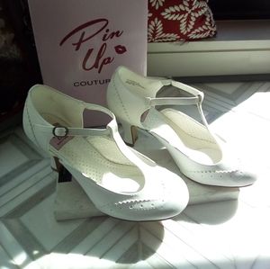 WHITE T_STRAP MARY JANE KITTEN HEELS. ALL MAN MADE MATERIALS.